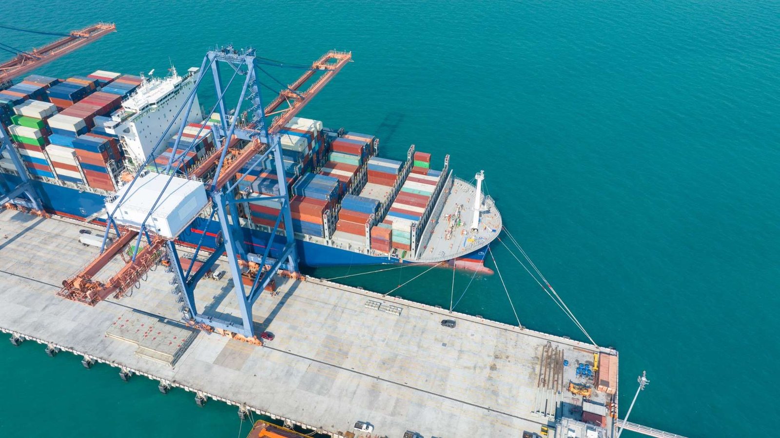 Container ship loading at a port terminal with a quay crane